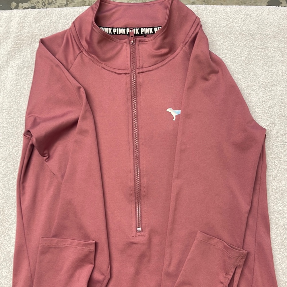 Pink pullover work out jacket has NO size in side the jacket